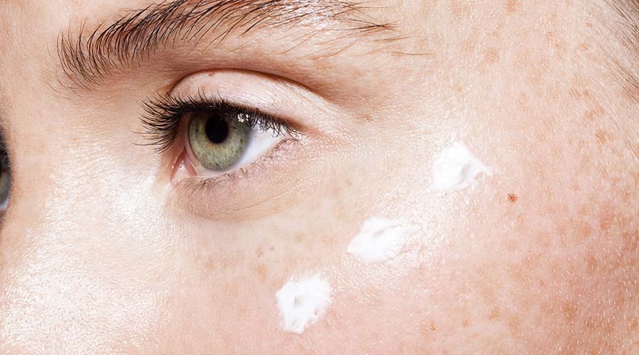 Application d’un soin contour des yeux naturel pour hydrater la peau fine et atténuer les rides sous les yeux.