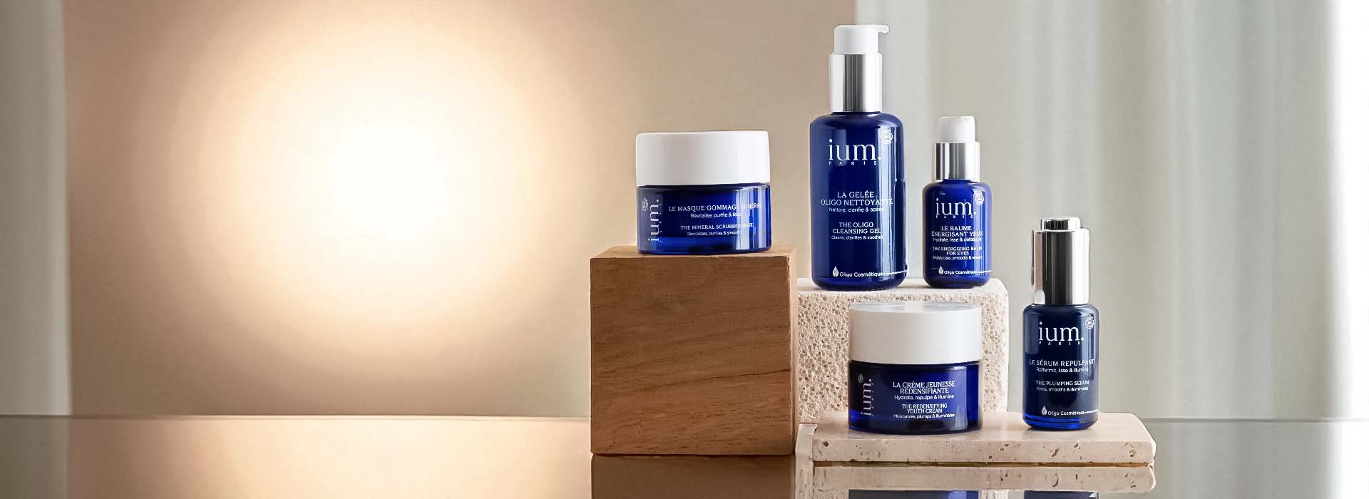 Complete range of IUM Paris trace element facial care products, in recyclable blue glass bottles.
