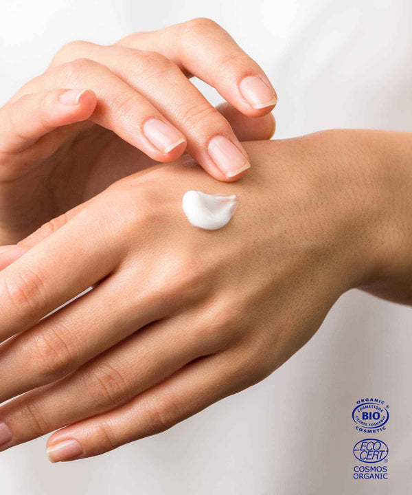 Youthful ium cream texture on woman's hand