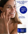 Smiling woman applying IUM Paris Redensifying Youth Cream, demonstrating its moisturizing, protective and firming benefits, with a soft, non-greasy, non-sticky texture, proven effective with 97% luminous skin.