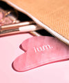 Pink Quartz Gua Sha massage stone exceeds a make-up case