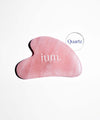 Gua Sha stone in ium rose quartz on white background 